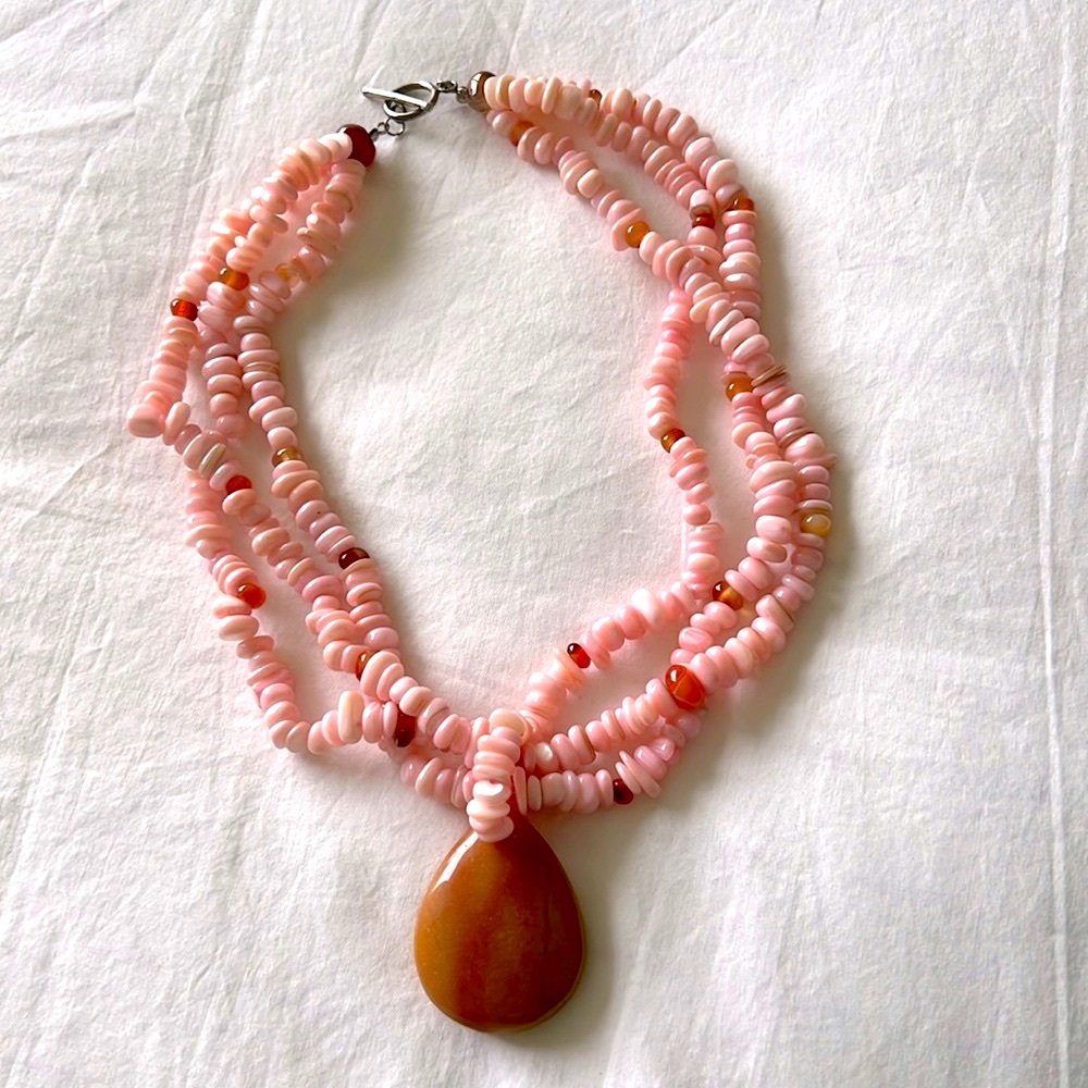 Stone necklace. Three strands. Pink. 17” long.